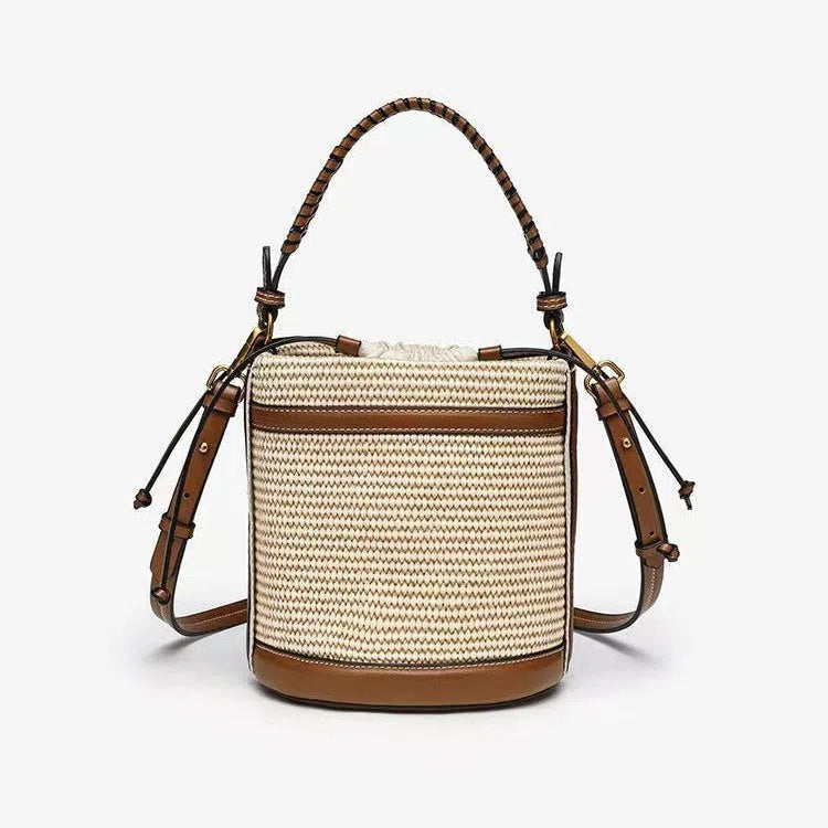 Brown PU cylindrical tote bag with dual handles and woven decorative stitching lines.