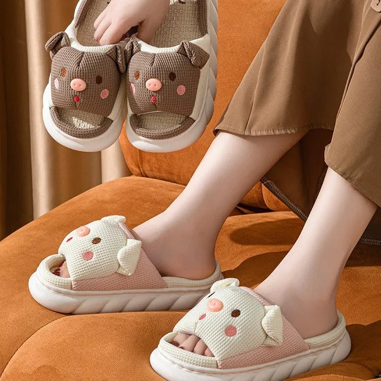 A pair of open toe linen slippers for couples on a light background, showing the flip-flop style and linen upper texture.