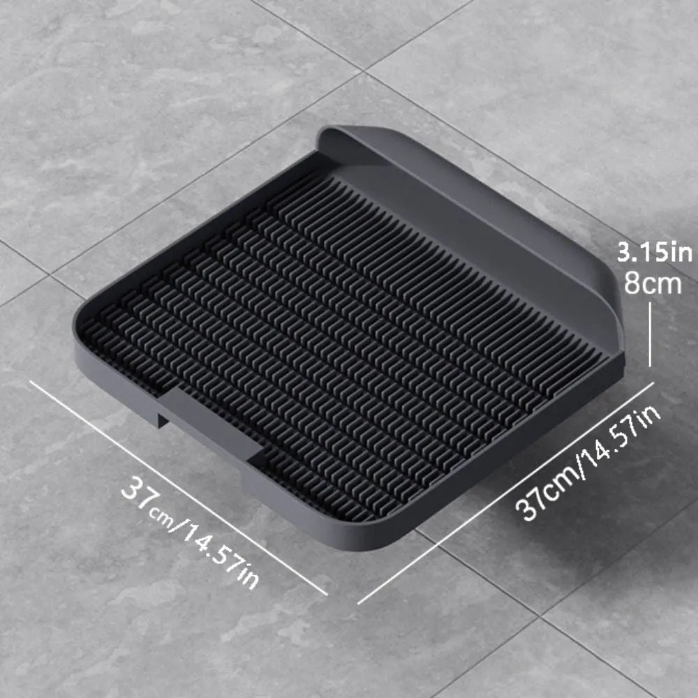 Large black cat litter pedal mat with slanted mouth design and textured surface