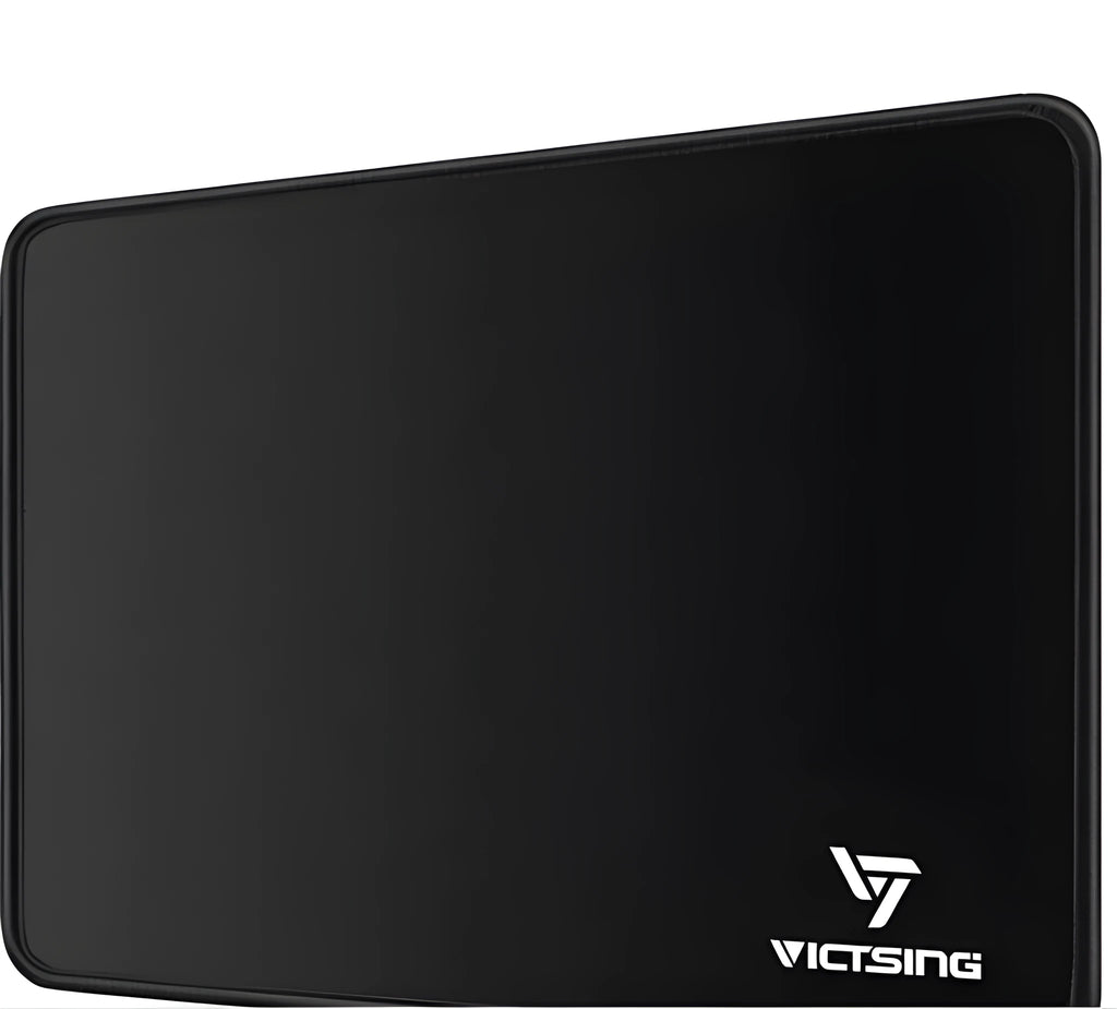 Black thickened rubber mouse pad with rough grain surface texture on desk
