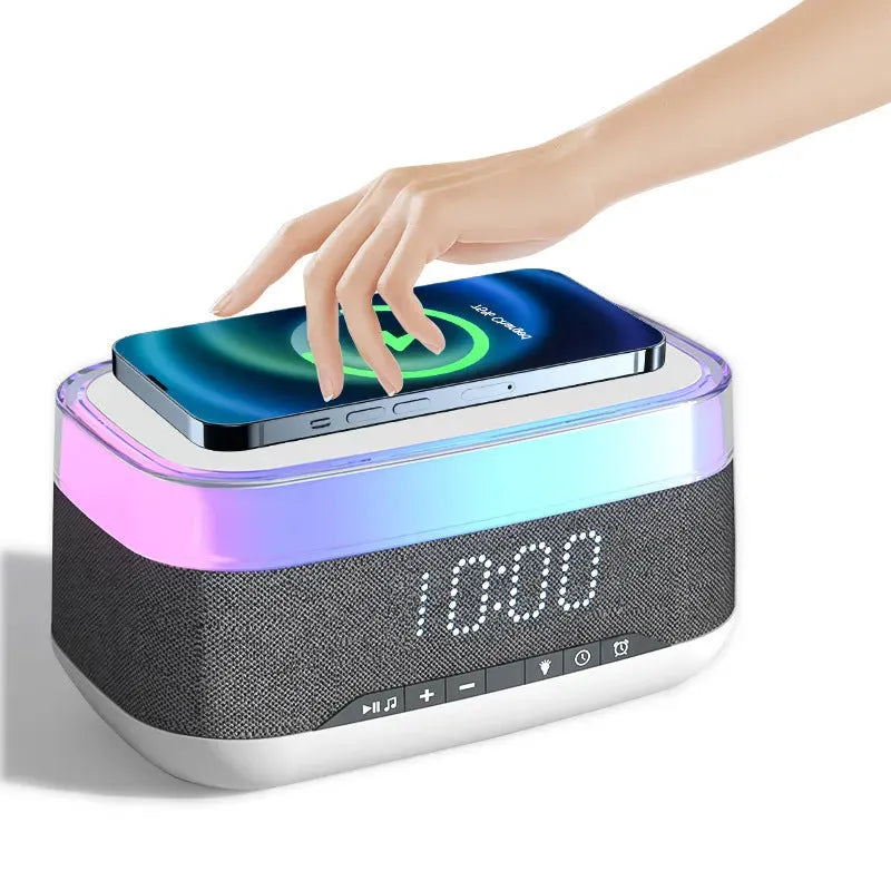 White multifunctional alarm clock with Bluetooth speaker and wireless charging pad for mobile phones