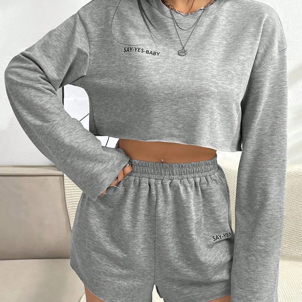 Women's grey long-sleeved t-shirt and shorts matching polyester set laid flat showing both pieces