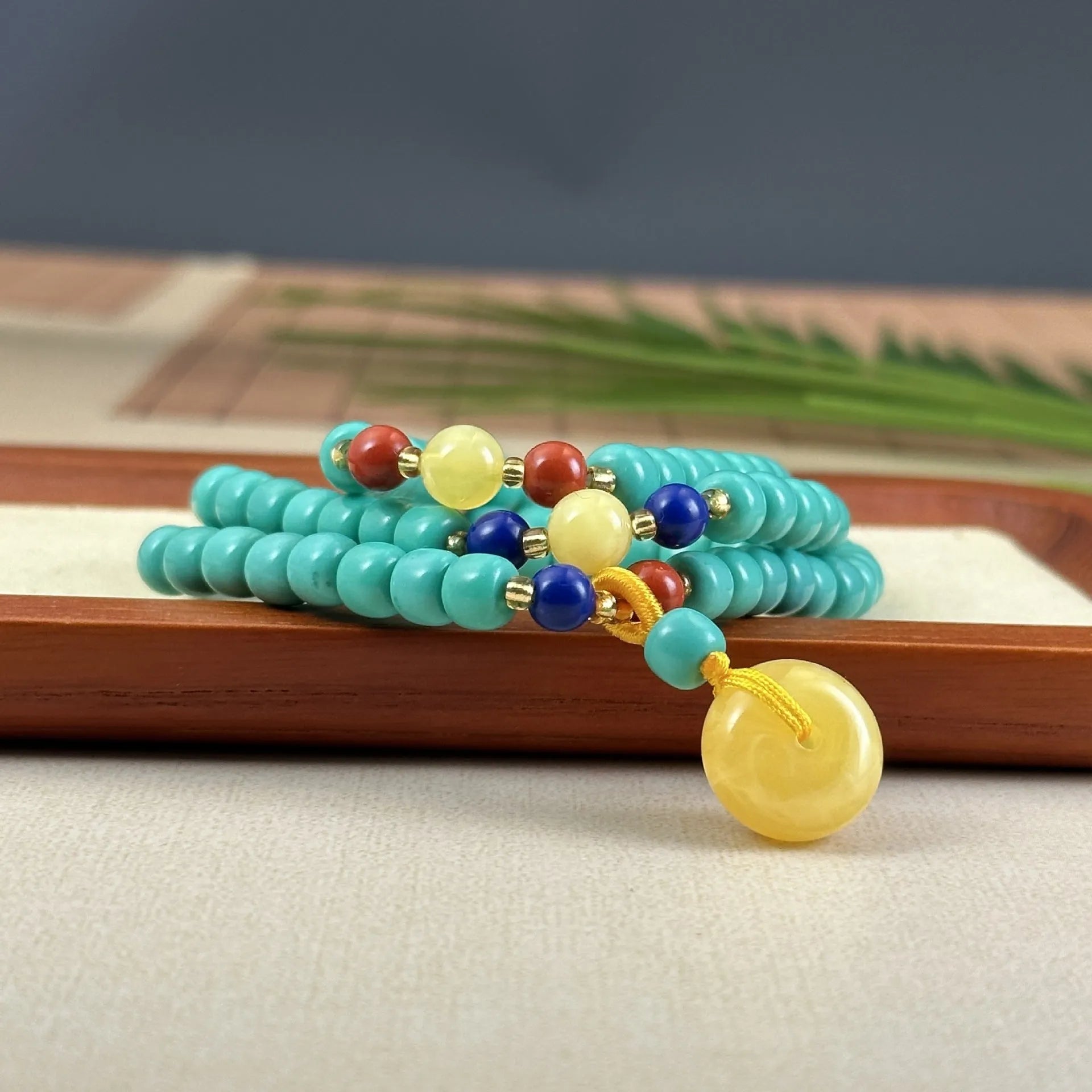 Turquoise mesh flower pendant on an adjustable ball bead necklace chain.