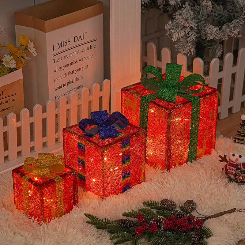 Set of three lighted Christmas gift box decorations with bows and LED lights for outdoor holiday decor