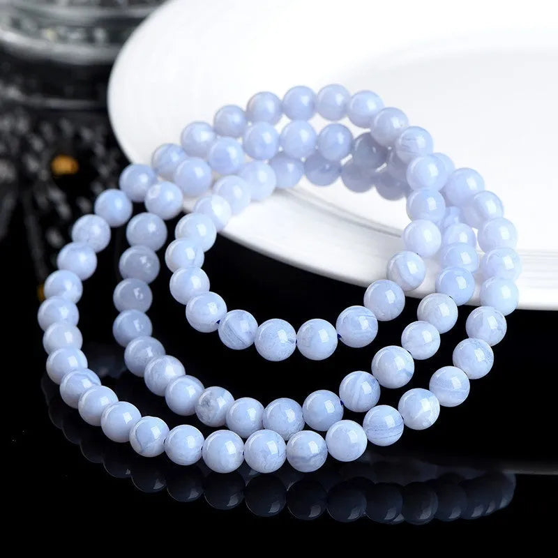 Original unisex blue agate beaded bracelet with natural striped patterns and ruyi elements.