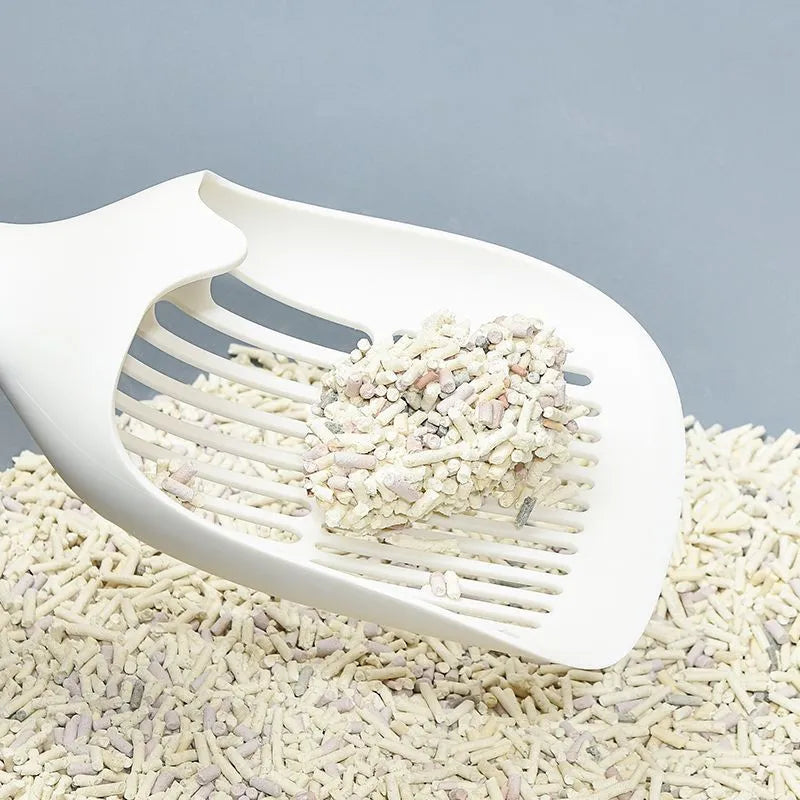 White plastic cat litter scoop with storage base for litter tray cleaning