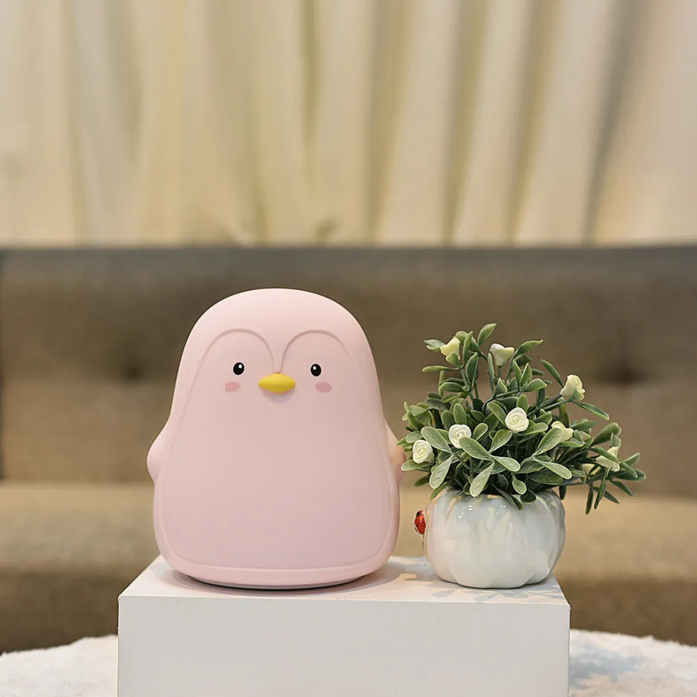 White silicone and ABS penguin-shaped rechargeable night light with USB cable