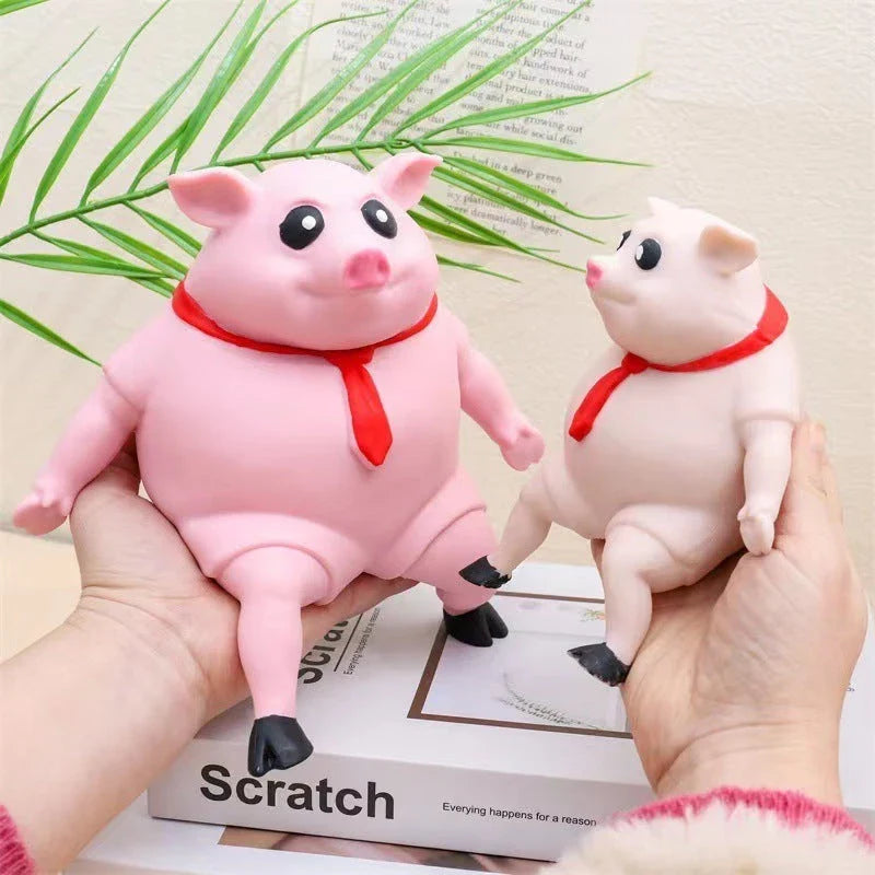 Piggy-shaped stress relief toys made from soft, eco-friendly rubber with cute scarf accents