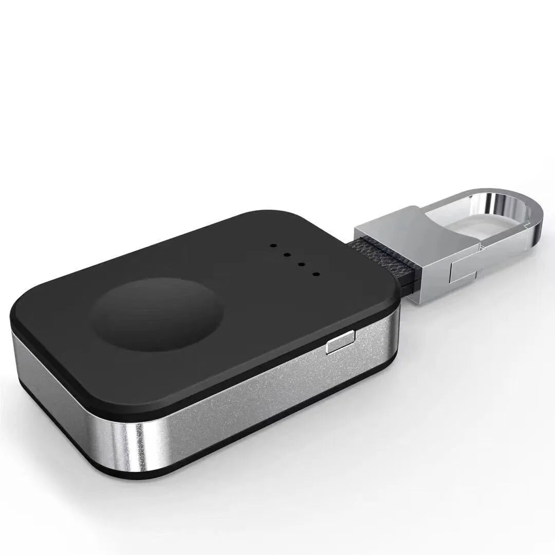 Black portable wireless power bank keychain for charging Apple Watch on a keyring.