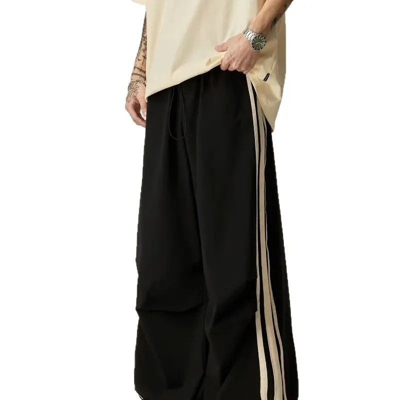 Black wide leg climbing pants for men showing high waist and straight leg design