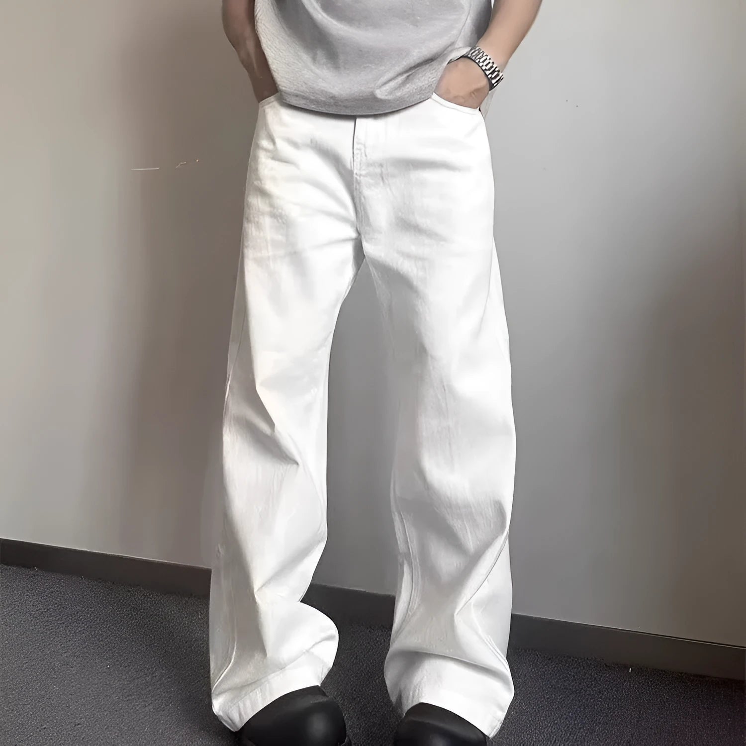 Men's white straight-leg cotton denim jeans on a hanger, showing the mid waist and wide leg opening.