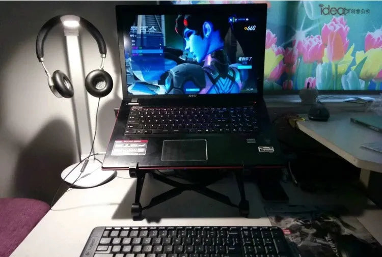 Black foldable portable laptop stand with enhanced nylon construction shown with travel case