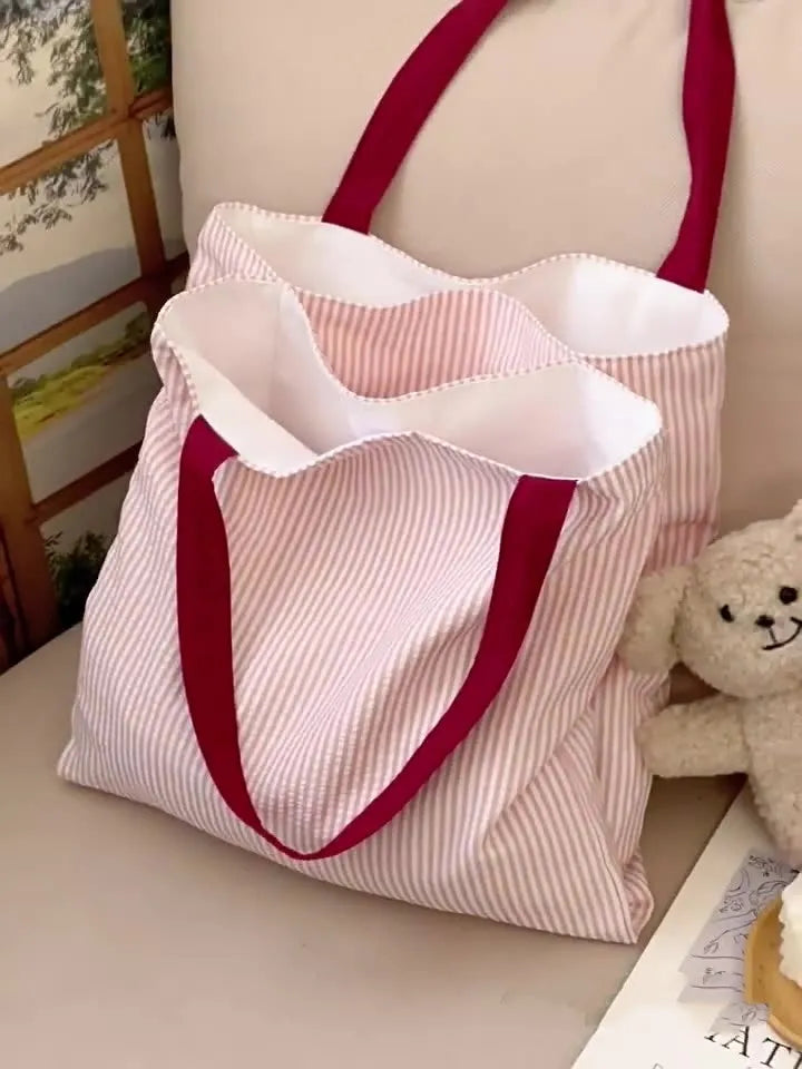 Canvas multi-layer tote shoulder bag showing three colour options: light pink stripes, black and gray plaid, dark gray stripes