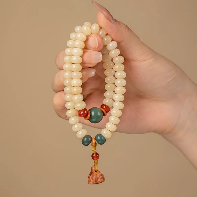Wooden Bodhi root bracelet with flat round 6x9mm beads in milk butter colour