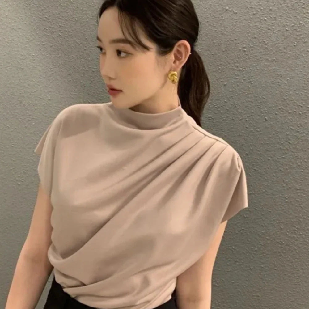 Women's apricot shirt with stand-up collar, diagonal pleats, and flowing short sleeves on hanger