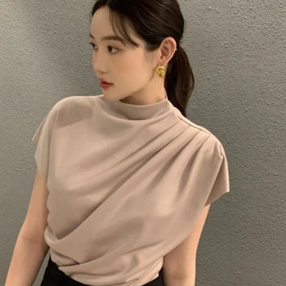 Women's apricot shirt with stand-up collar, diagonal pleats, and flowing short sleeves on hanger