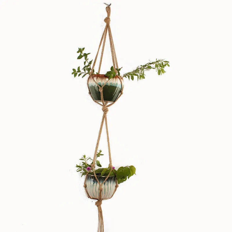 Natural jute cotton rope woven macramé plant hanger in a layered design for wall or ceiling hanging.