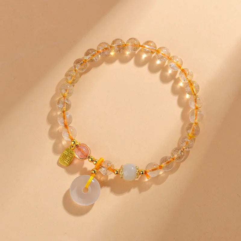 Gold rutilated quartz crystal bracelet with peace buckle closure and blessing card pendant