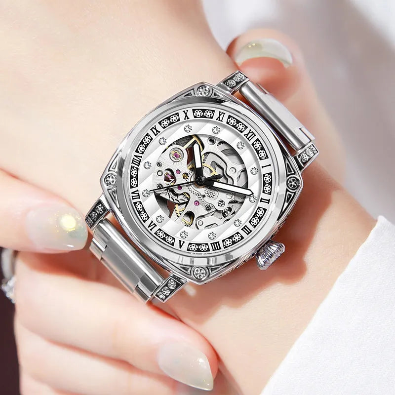 Mechanical watch with luminous hands and a brown leather strap, showing white dial.