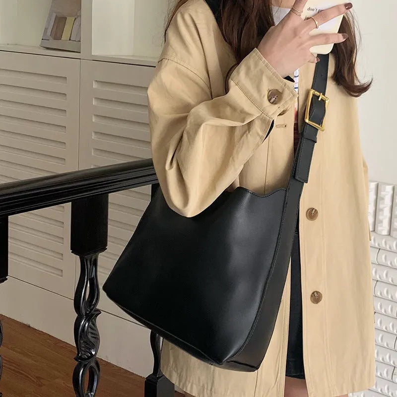 Women's solid colour PU leather shoulder bag in black, square vertical shape with sewing thread detail and single strap