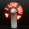 White handheld mini fan with a flashing LED love pattern display.