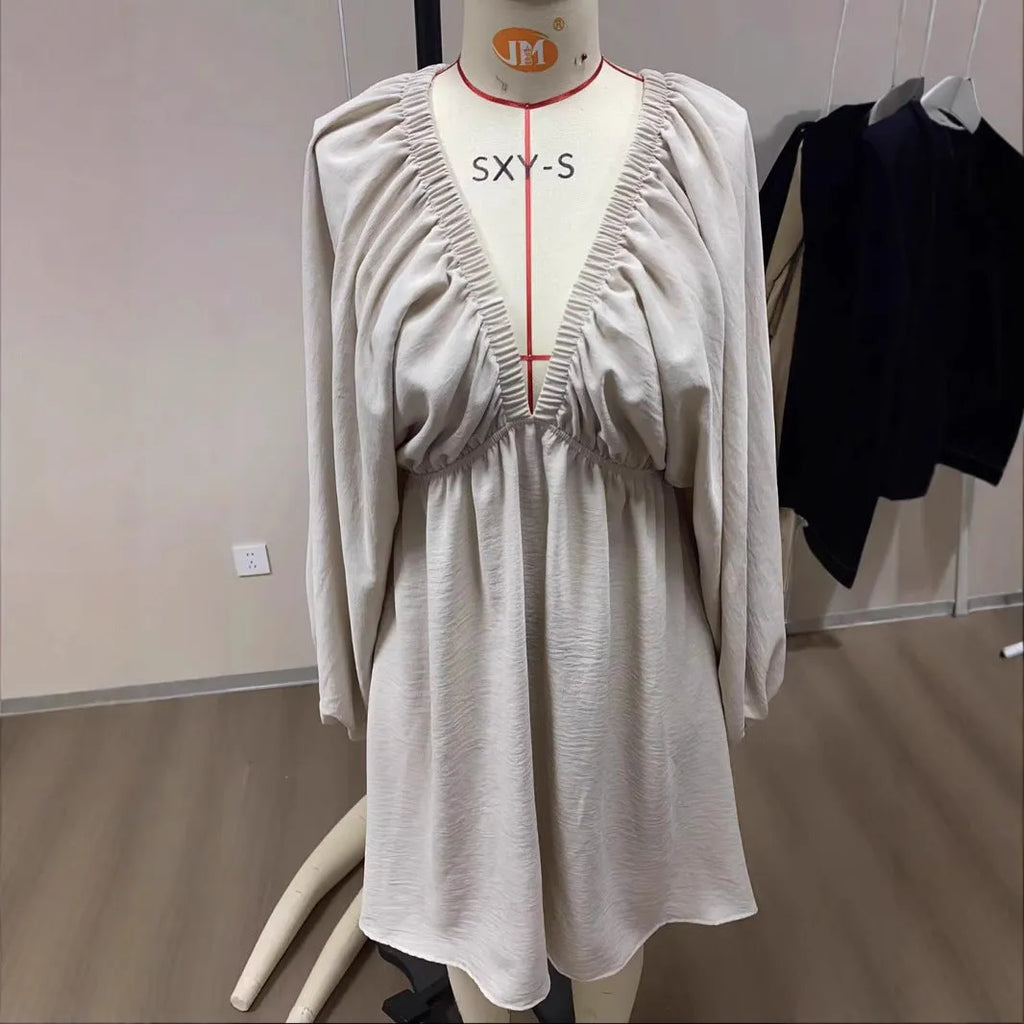 Women's apricot V-neck dress with long puff sleeves and a flounced swing skirt, mid-waist design.