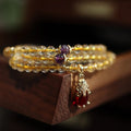 Natural Brazil rutilated quartz bracelet with golden needles and Chinese style hanging chopsticks design
