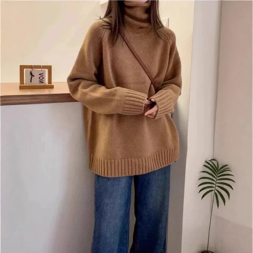 Women's loose thick grey turtleneck sweater with curling pile collar, casual pullover style.