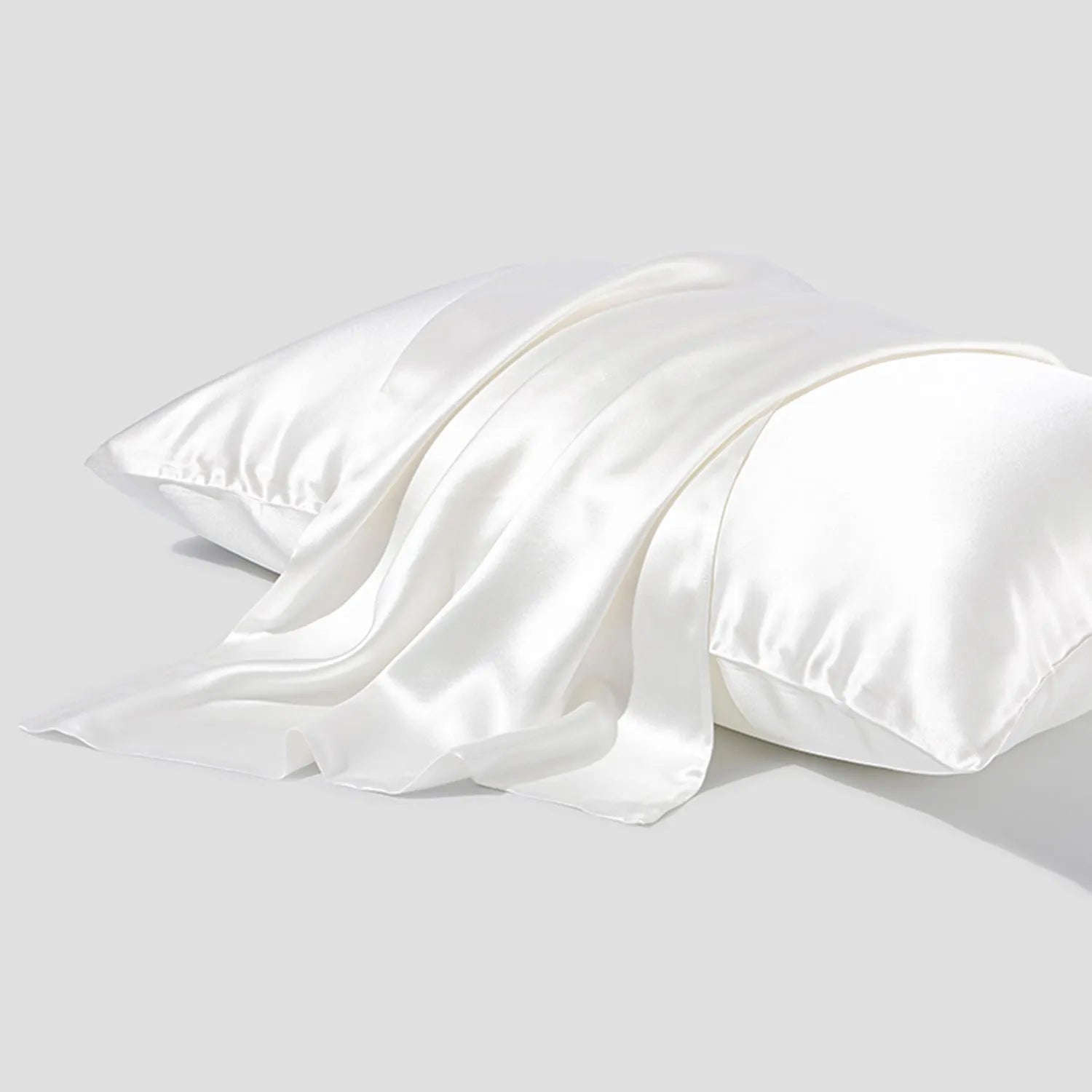 Dark grey mulberry silk pillowcase with envelope closure, shown in a modern bedroom setting.