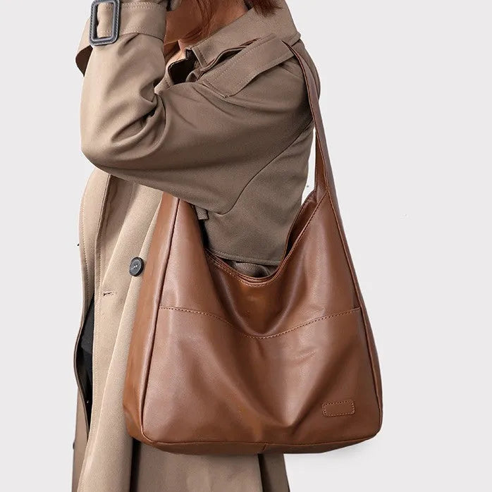 Women's soft PU leather retro shoulder bag in black with single strap and open pocket.