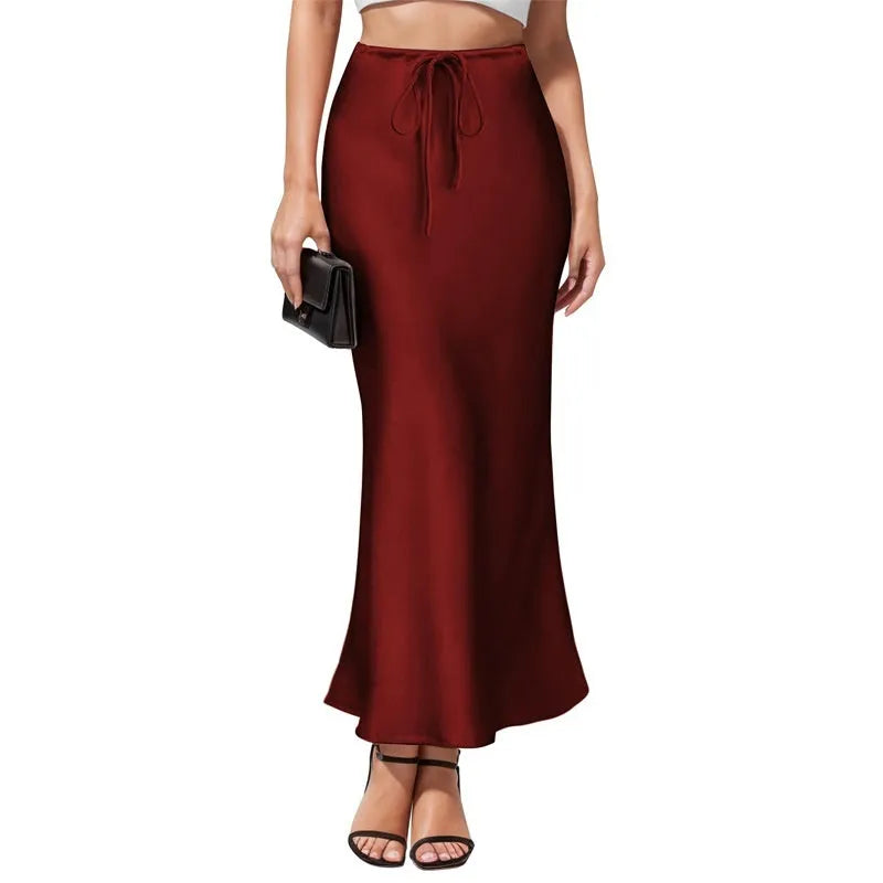 High-waisted asymmetric acetate satin skirt in a solid colour with irregular stitching detail.