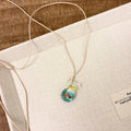 Women's skirt-shaped joker pendant necklace on a cotton and linen clavicle chain.