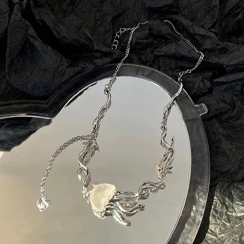 Alloy jellyfish tassel necklace and earring set in electroplated white finish on display