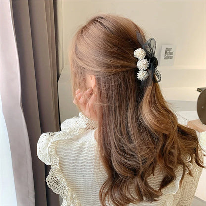 Korean pearl bow hair clip in black with alloy construction and manual bowknot design