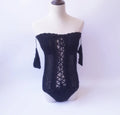 Off-shoulder one-piece swimsuit in European and American sizing on a model.