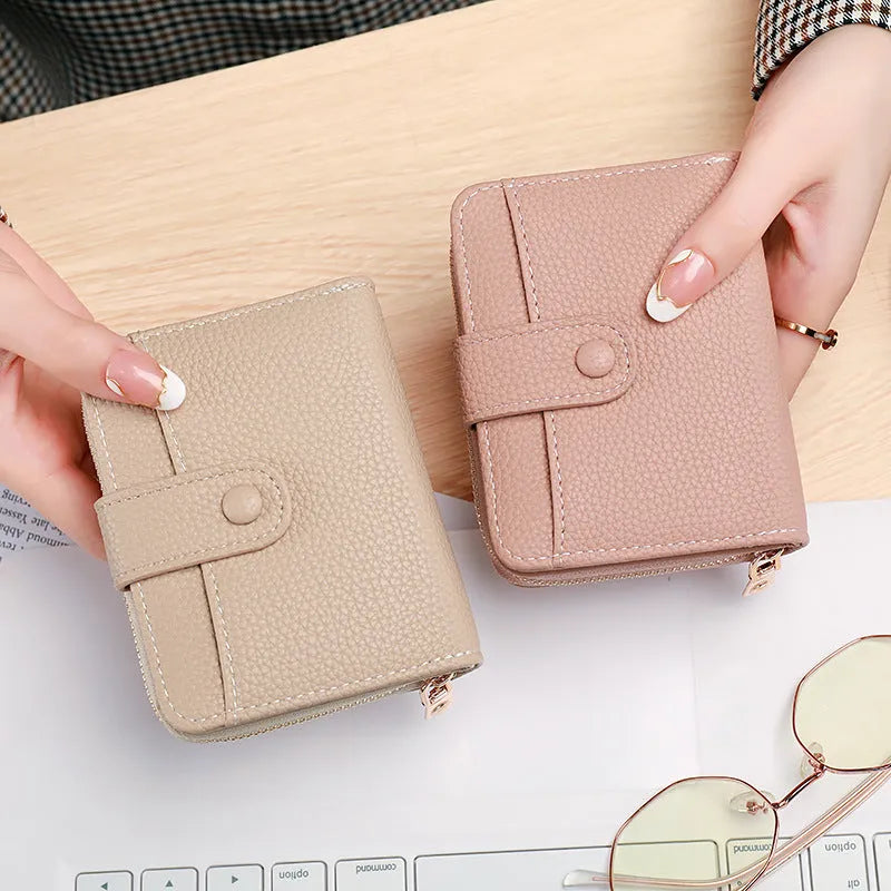 Ladies short wallet with lychee pattern in two-fold PU leather construction