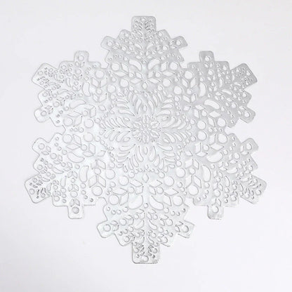 Stylish snowflake-patterned placemats in gold and silver, designed for heat resistance and spill protection on dining tables