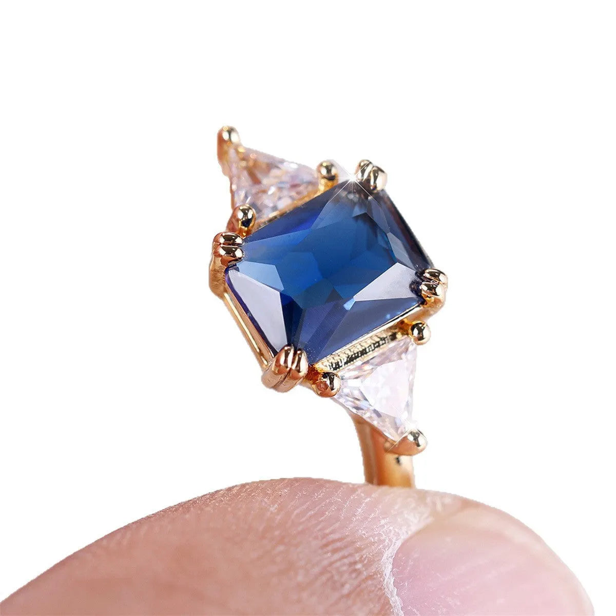 Rectangular copper ring with gold sapphire blue finish, shown on hand