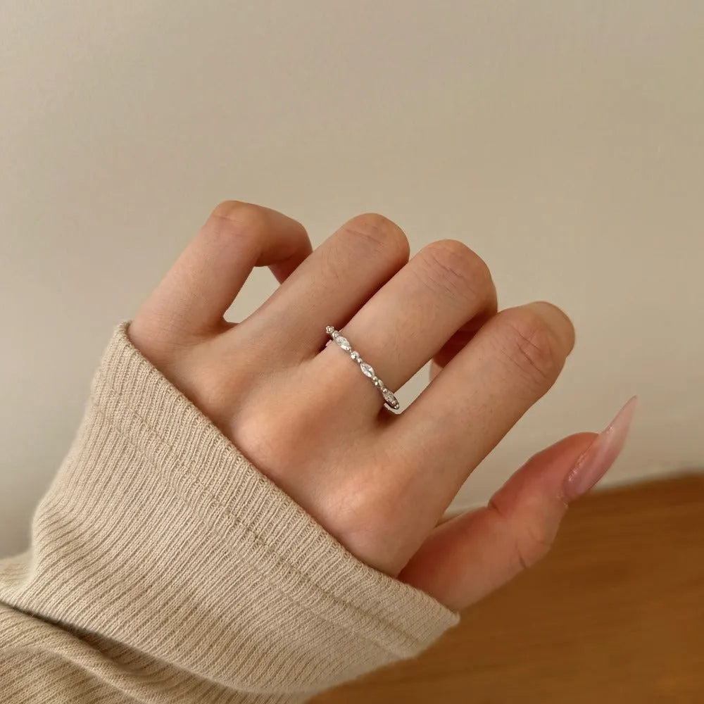 Silver rhombus ring with electroplated platinum finish on white background
