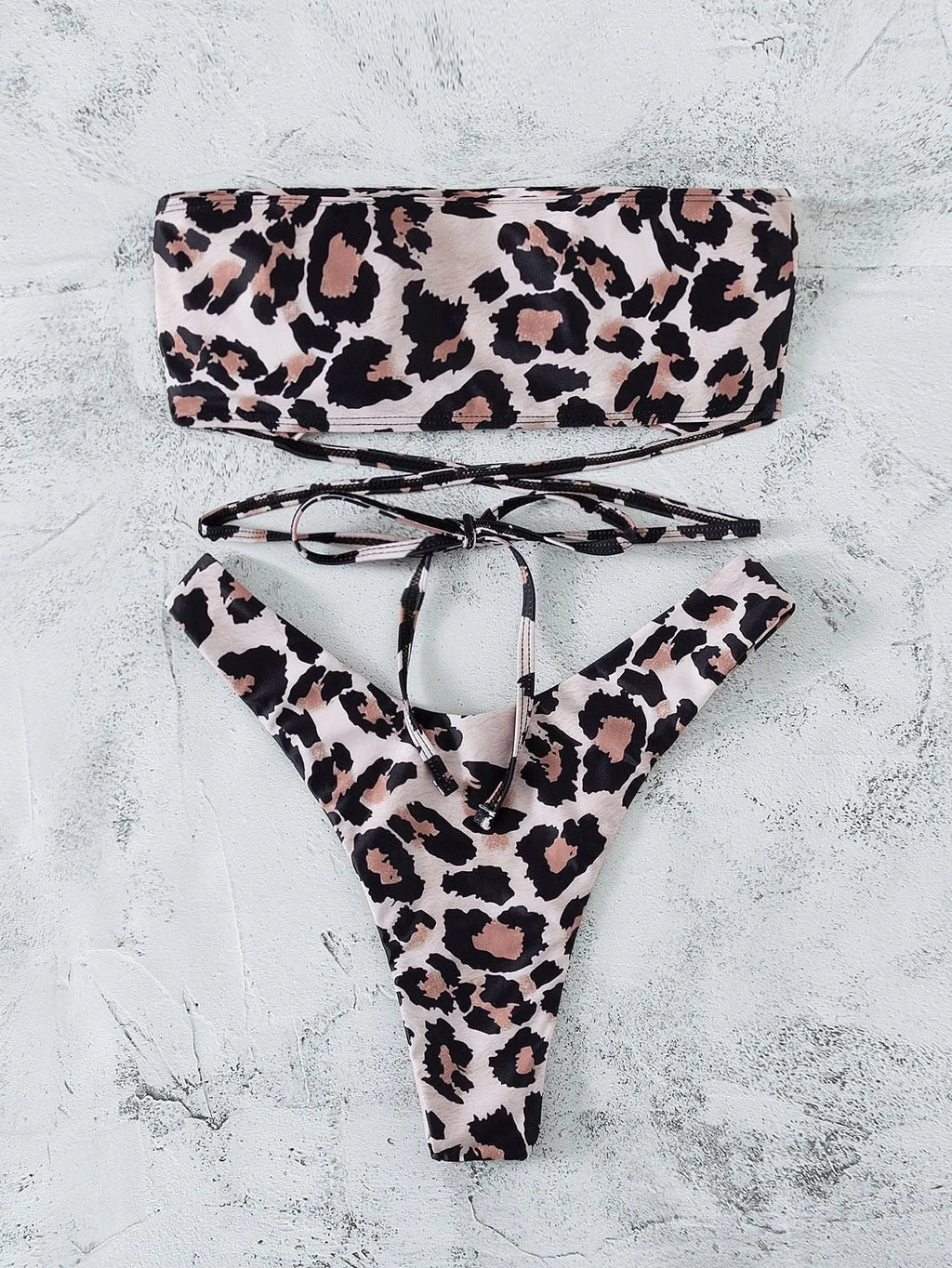 Leopard print bandeau split bikini swimsuit with removable chest pads on woman at beach