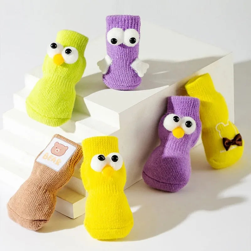 Dog all-season universal cotton socks with cute big eyes, anti-slip sole, green colour, side view on wooden floor