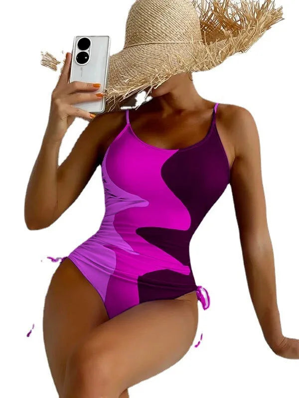 Blue sleeveless backless one-piece swimsuit for women on a mannequin, showing the tight-fitting striped design.
