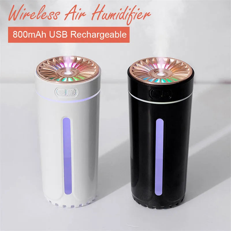 Compact black wireless USB humidifier with colourful LED lights on a car cup holder.