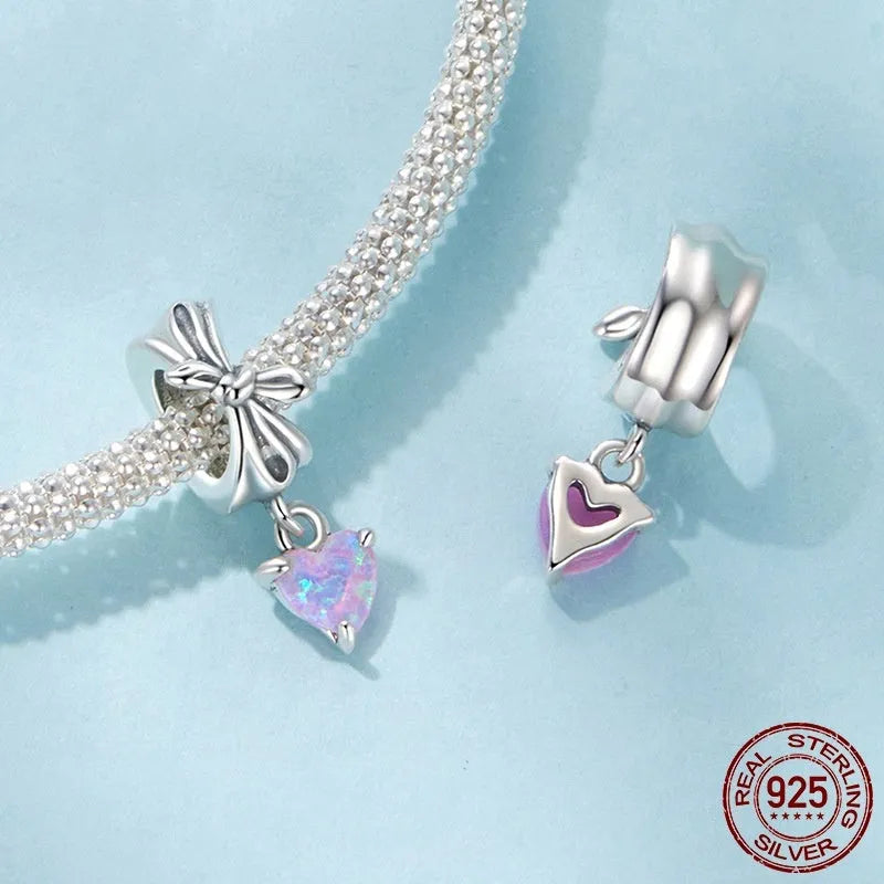 S925 sterling silver pendant with opal bow and loving heart motif, 1.6cm height, on white background