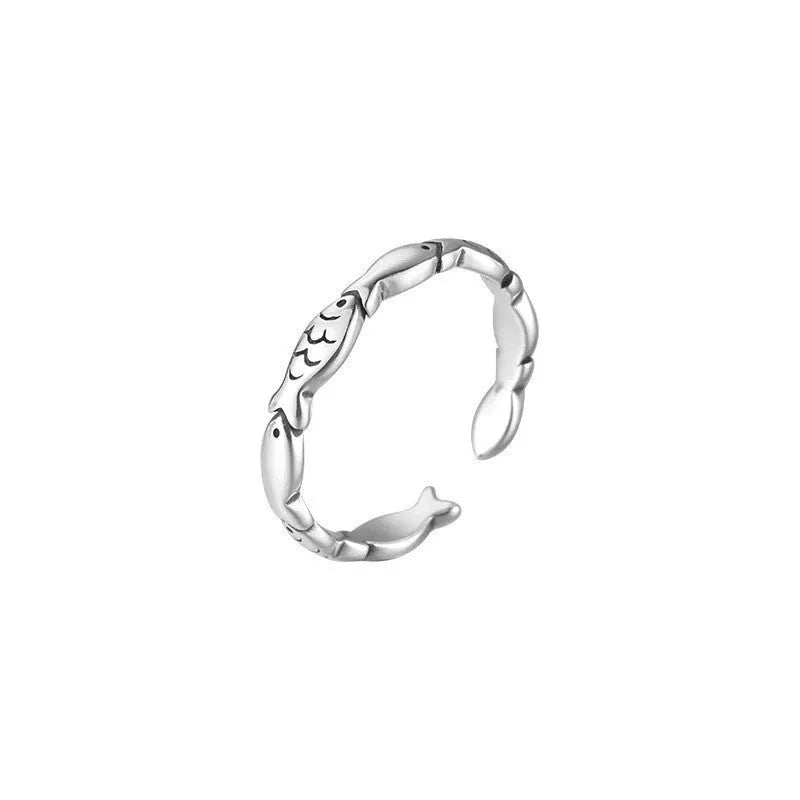 Close-up of a women's adjustable S925 sterling silver ring featuring a detailed fish (carp) design.