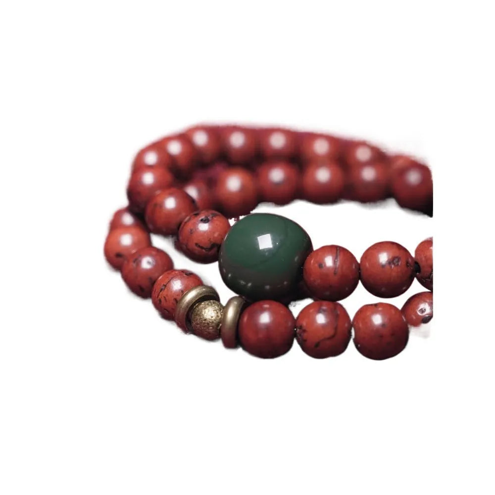 Handmade double circle charm bracelet strung with brown bodhi seeds on a white background.