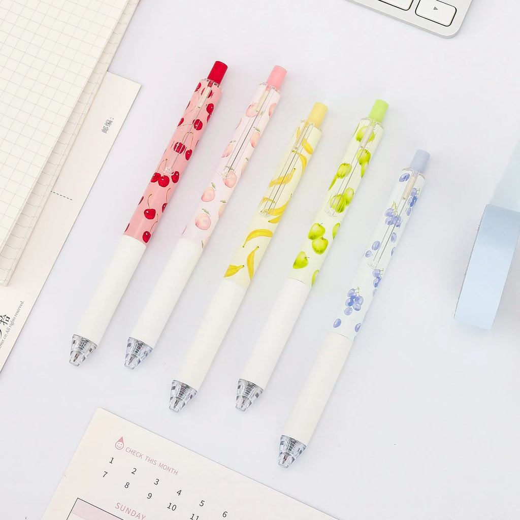 Three scented fruit ballpoint pens with press-action mechanism showing extended writing tips