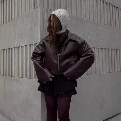 Stylish women's leather jacket with zipper detail in burgundy and black