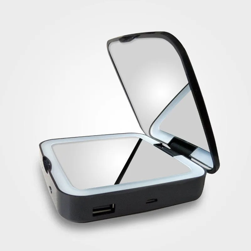 Black and white makeup mirror showing a magnifying side and a normal mirror with LED light ring.