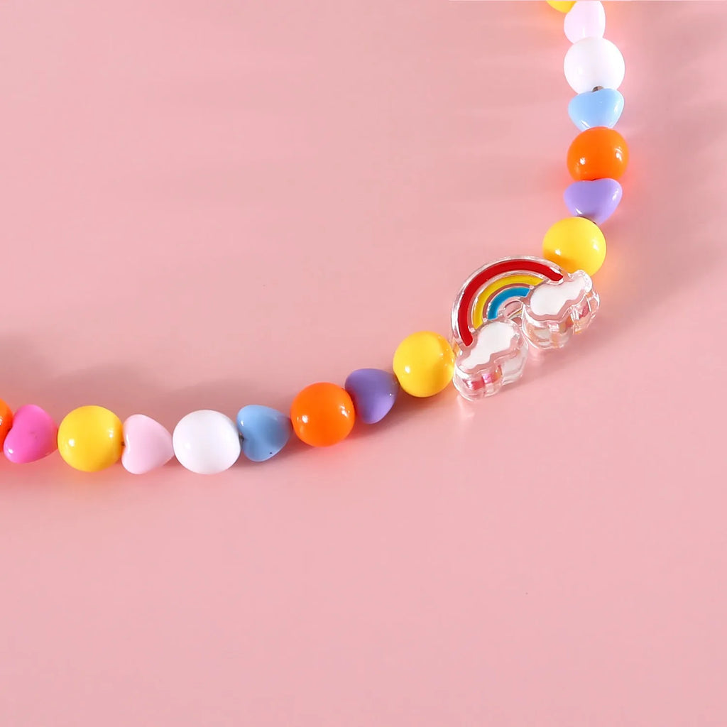Colourful plastic bead necklace for cats in peach, rainbow, or small flower patterns with adjustable XS or S sizing